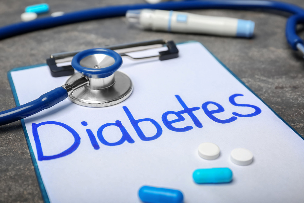 Komposition aus dem Wort „Diabetes“, Stethoskop, Tabletten und Kapseln auf einem Tisch Komposition aus dem Wort „Diabetes“, Stethoskop, Tabletten und Kapseln auf einem Tisch