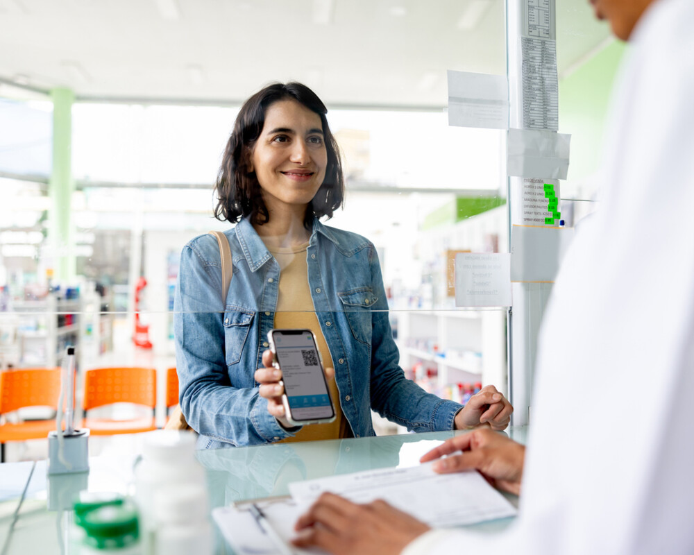 Kundin löst in der Apotheke ein elektronisches Rezept (E-Rezept) ein.