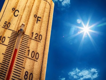 Thermometer vor einem gleißend blauen Himmel, das 40 Grad Celsius beziehungsweise den entsprechenden Wert in Grad Fahrenheit anzeigt.