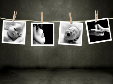 Wäscheleine, an der Bilder von Babys und einer Schwangeren hängen.