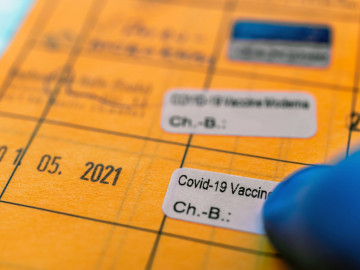 Impfpass mit Aufkleber für COVID-19-Impfung