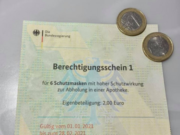 Berechtigungsschein und zwei Euro