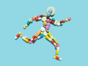 Laufender Mensch aus Tabletten und Kapseln dargestellt